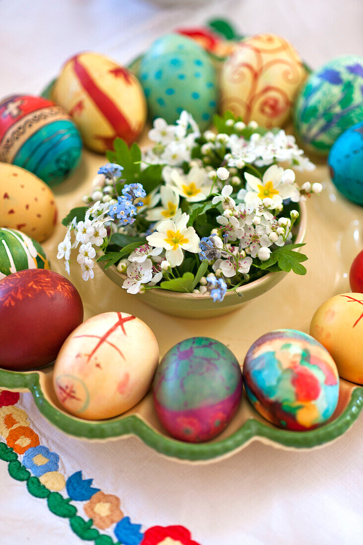 Hand-painted Easter eggs with forget-me-not and primrose in Essex home, England, UK