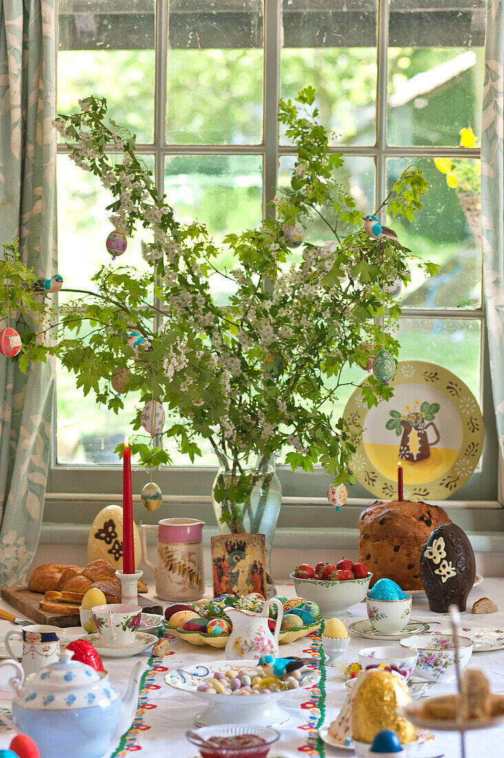 Spring blossom at window on Easter table in Essex home, England, UK