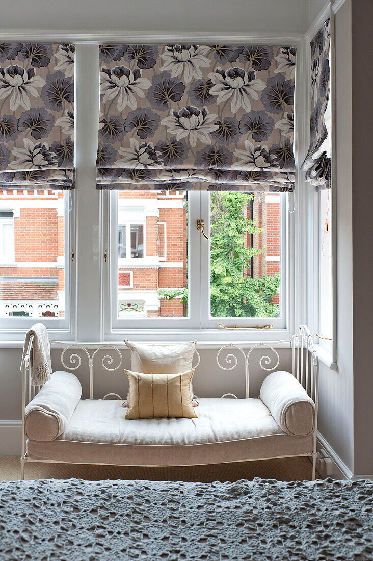 Daybed in window of bedroom in Middlesex family home, London, England, UK