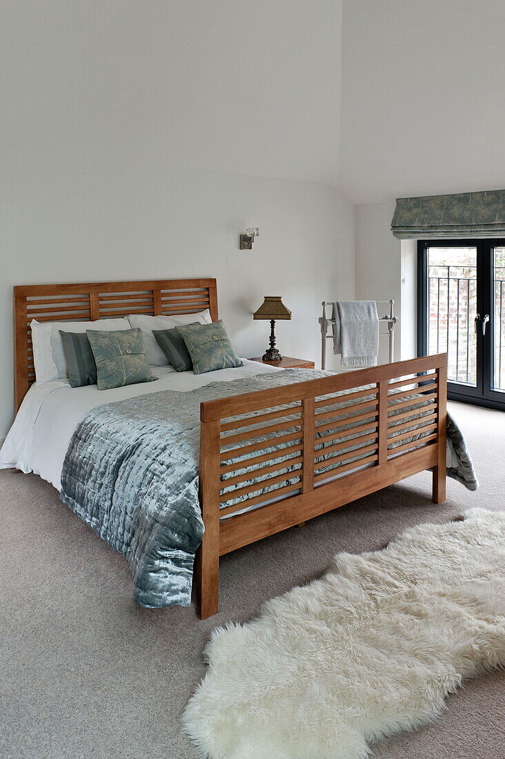 Contemporary wooden double bed in London home, England, UK