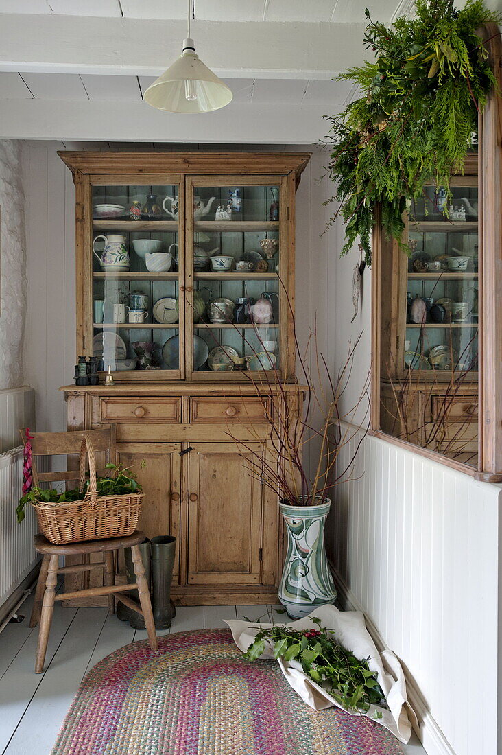 Wooden kitchen dresser with crockery in farmhouse, Cornwall, England, UK