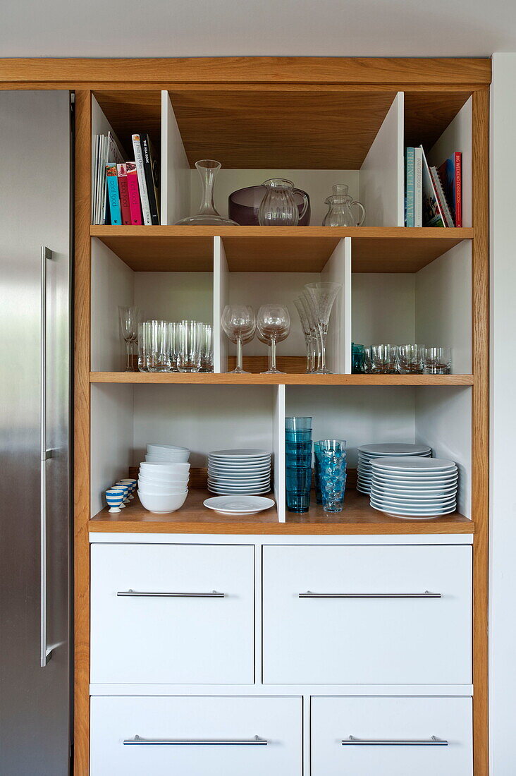Glassware and crockery storage in contemporary kitchen, Cornwall, England, UK
