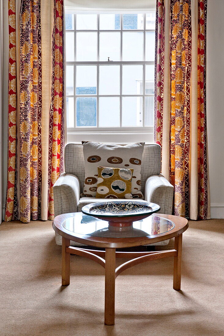 Retro armchair and coffee table in window of Padstow cottage, Cornwall, England, UK