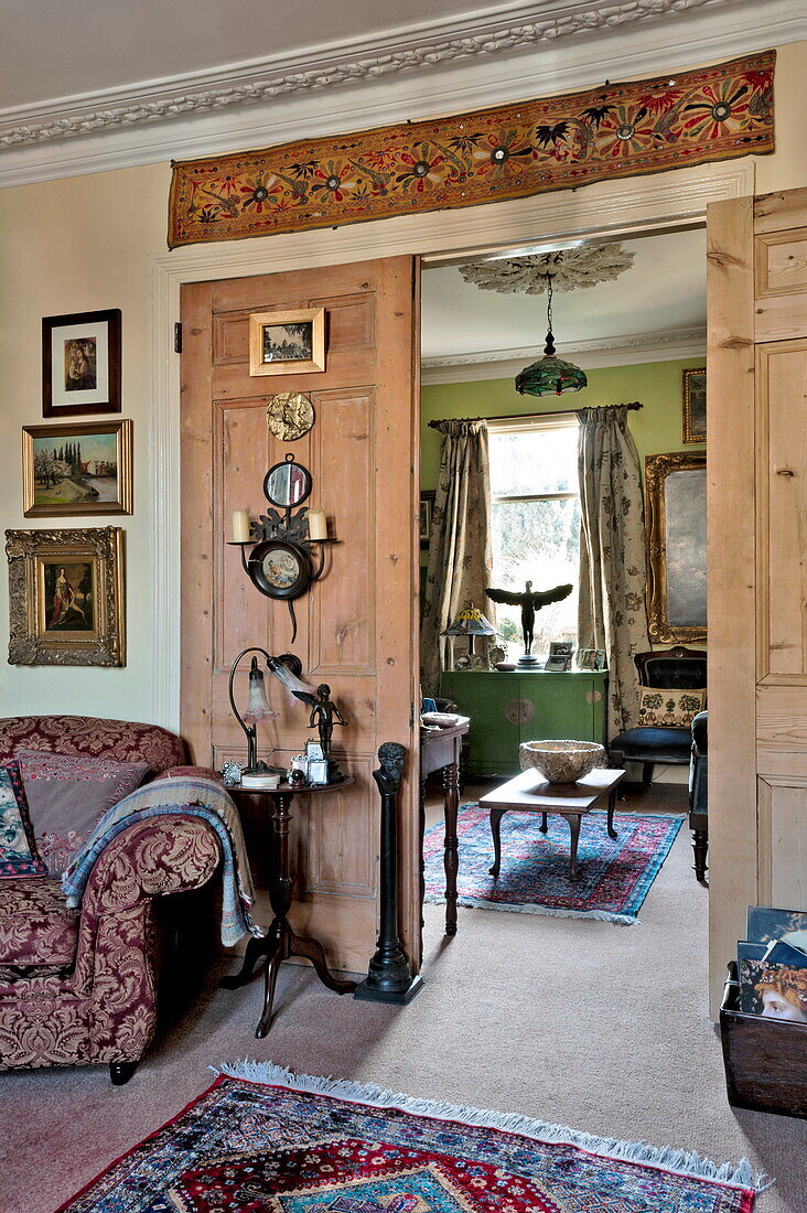 View through wooden doors to parlour in London home, England, UK