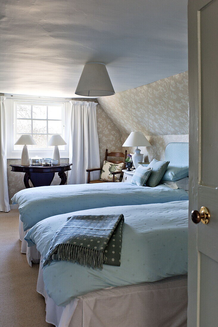Twin beds in attic room of Bury St Edmunds country home, Suffolk, England, UK