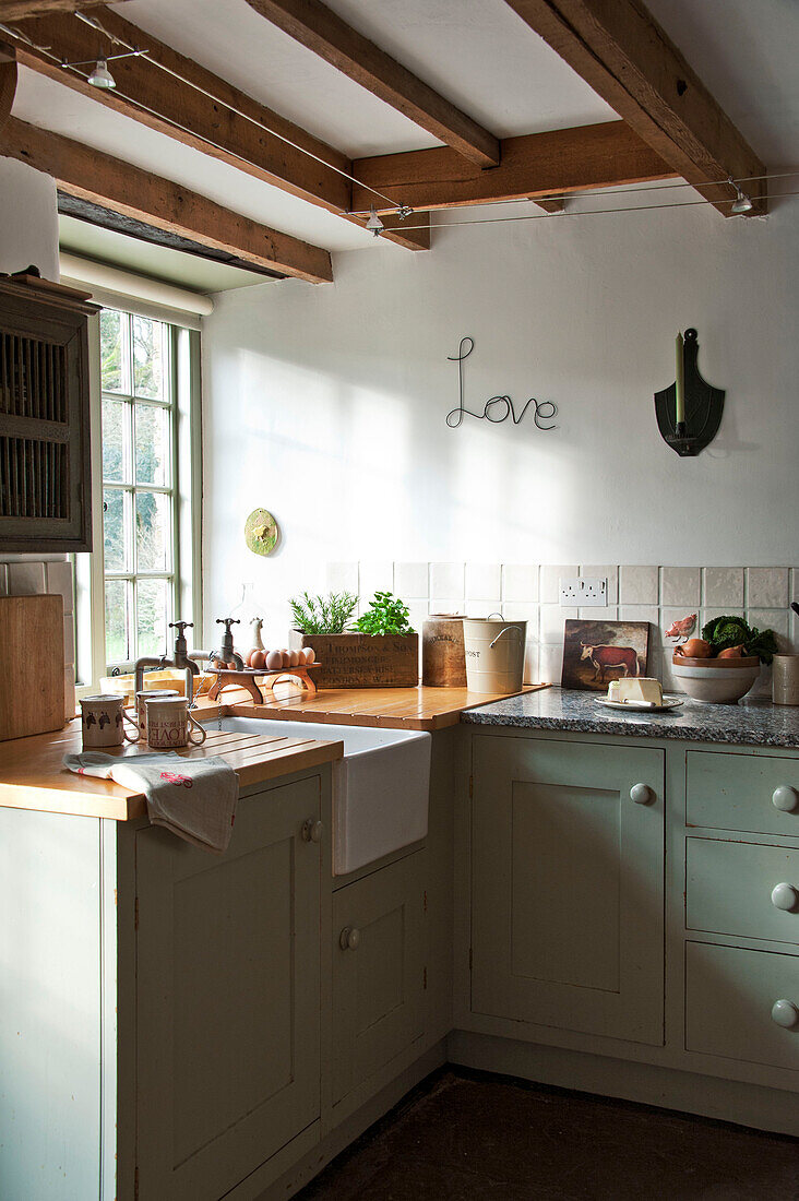 Kitchen sink with single word 'Love' at window of Sherford barn conversion Devon UK