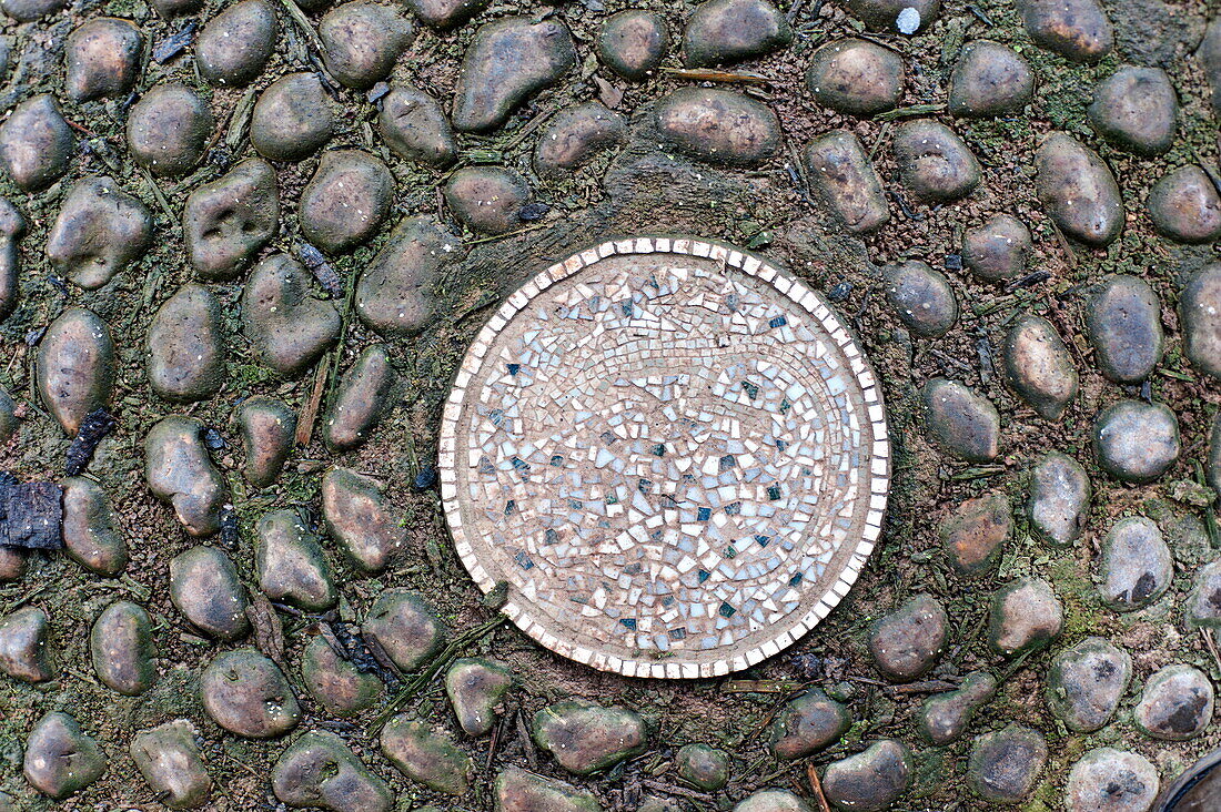 Garden mosaic in cobblestone garden path, Blagdon, Somerset, England, UK