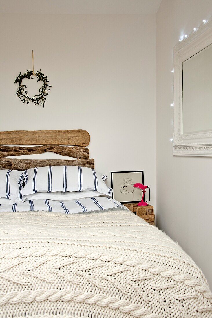 Driftwood headboard on double bed in Wadebridge home North Cornwall UK