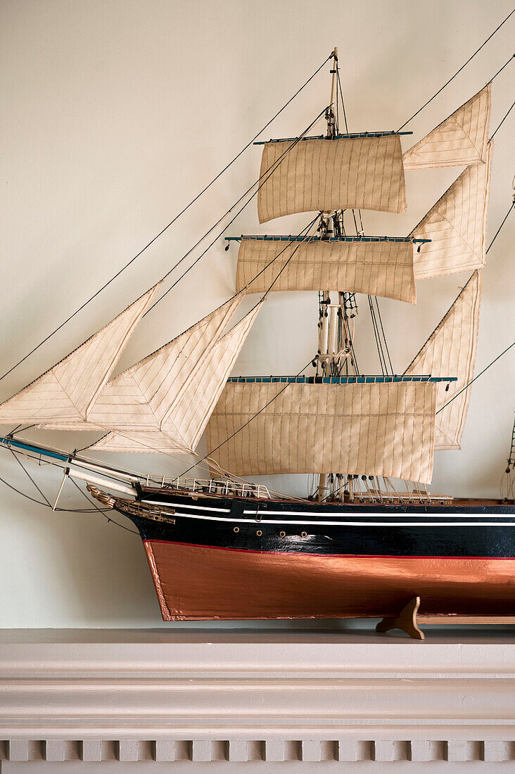 Model ship on mantlepiece in Cornwall, UK