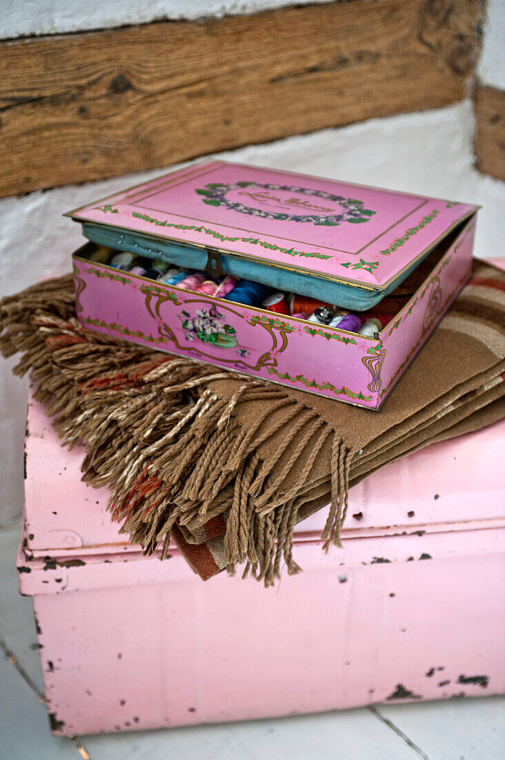 Pink sewing box with blanket in Cambridge cottage England UK