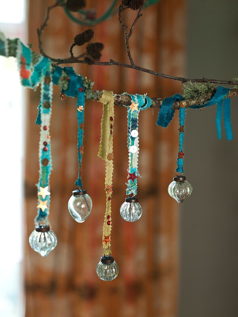 Glass baubles hang on ribbon in London home England UK