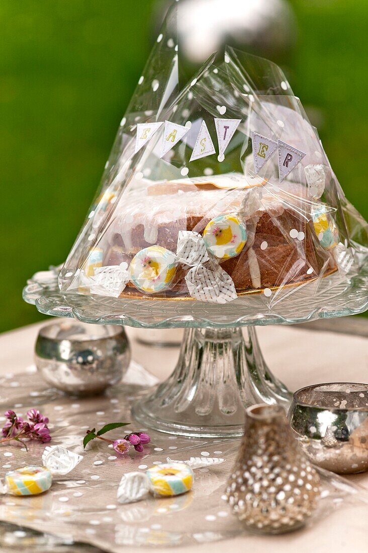 Easter cake on glass cake stand in Sussex garden UK