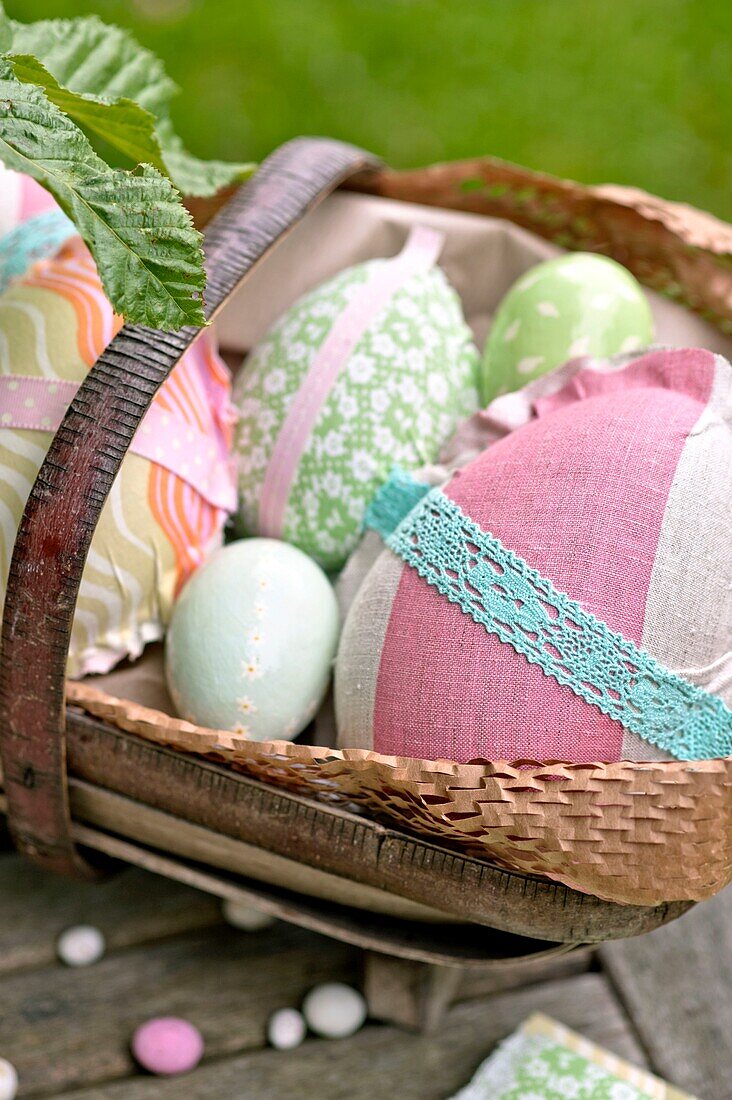 Hand made Easter eggs in basket on garden table Sussex England UK