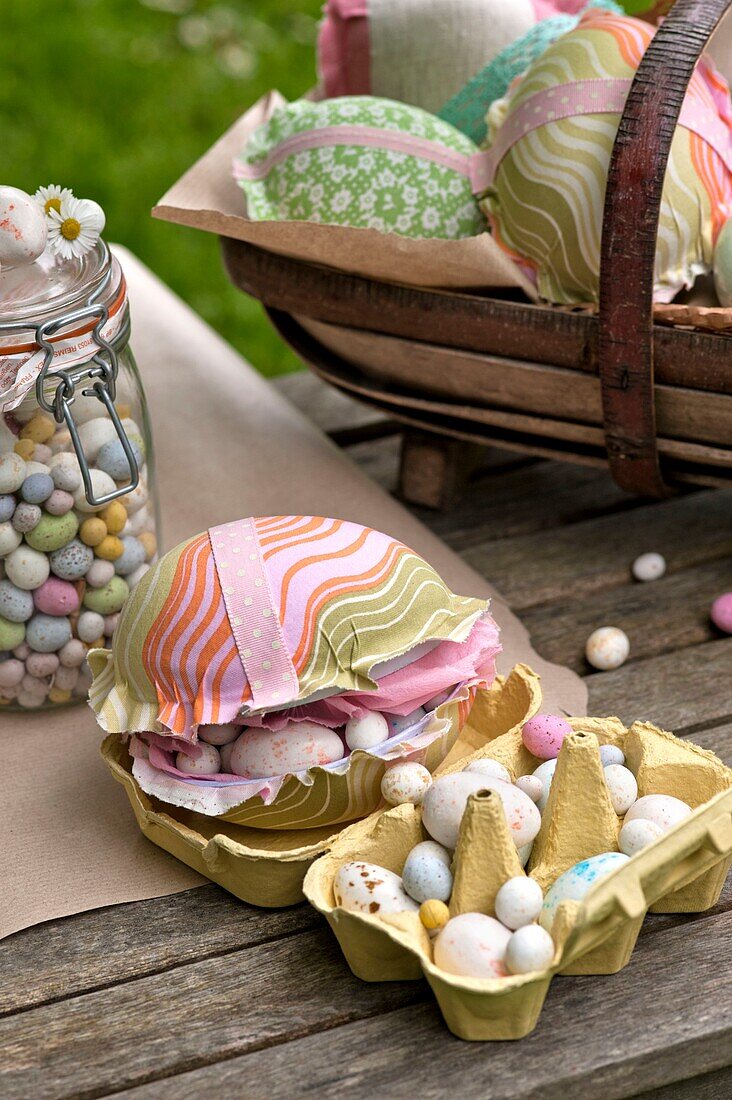 Easter eggs with egg box and basket on Sussex garden table England UK