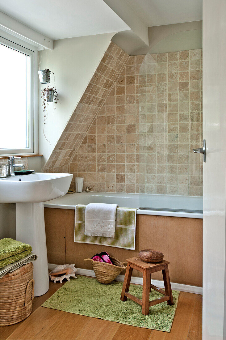 Tiled bathroom with pedestal basin East Grinstead family home West Sussex England UK