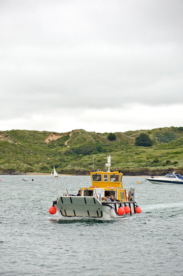 Passengers on ferry heading towards land Cornwall UK