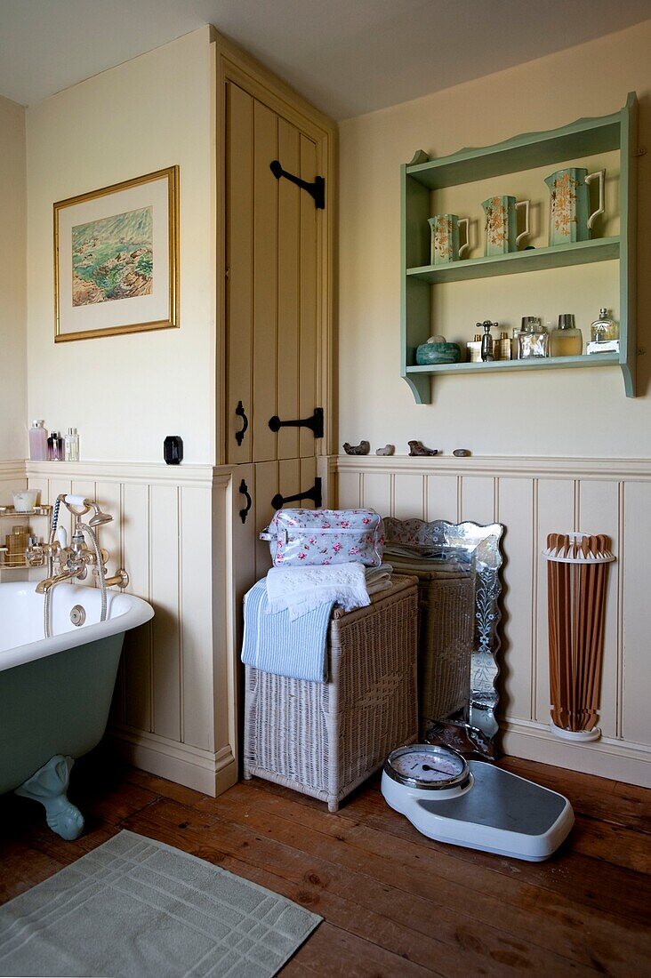 Floral washbag with wall-mounted shelving in Edworth bathroom Bedfordshire England UK