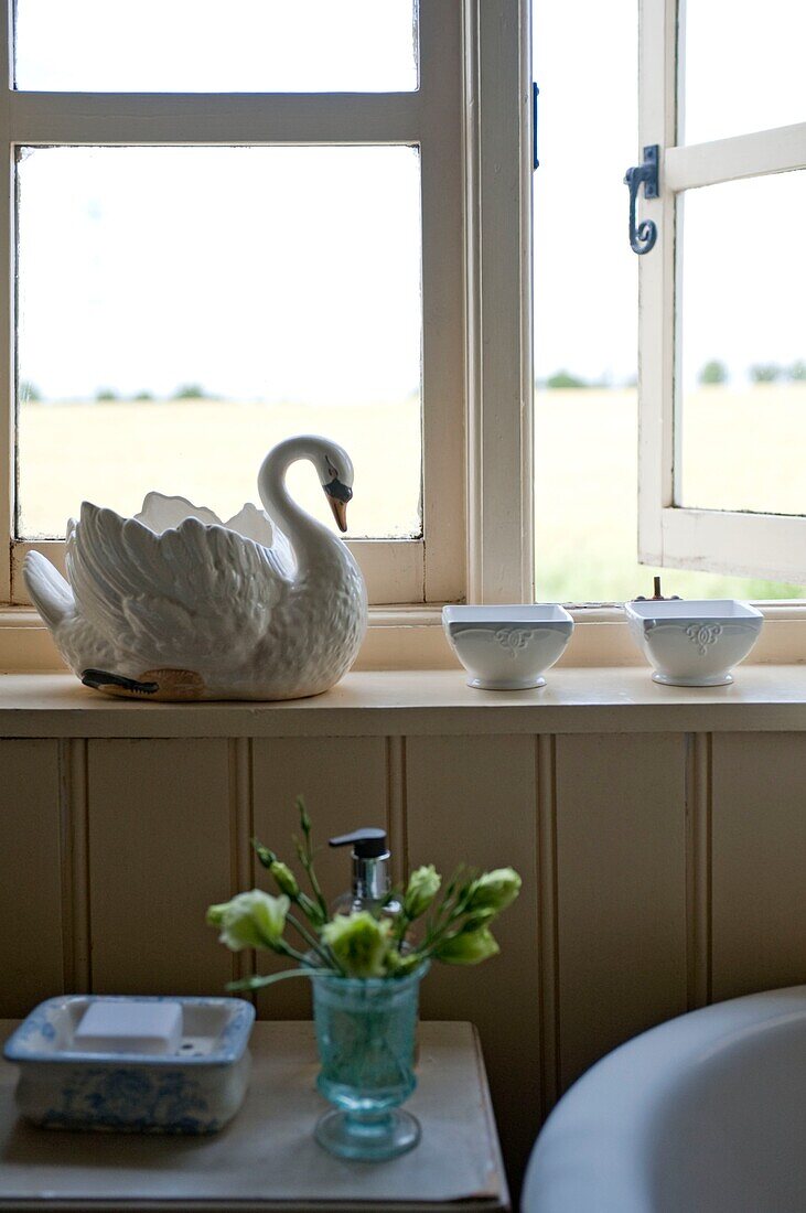 Swan ornament on bathroom windowsill in Edworth cottage Bedfordshire England UK