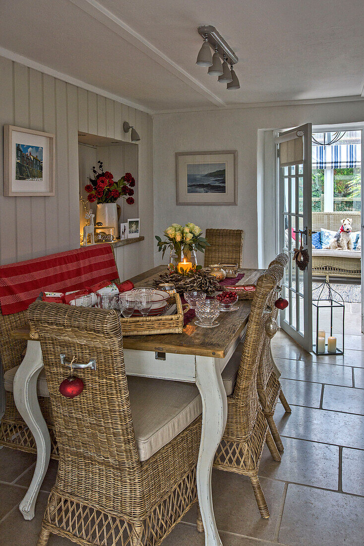 Wicker chairs at dining table at Christmas in Penzance farmhouse Cornwall UK