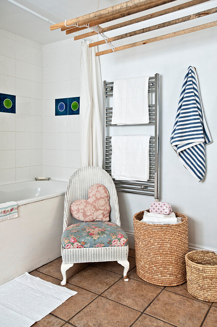 Wicker chair and laundry airer in bathroom of Cornwall cottage UK