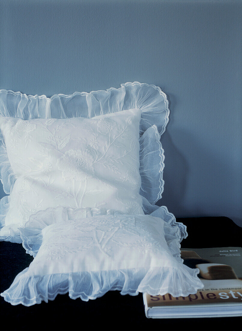 Lace pillowcases on bed with book 