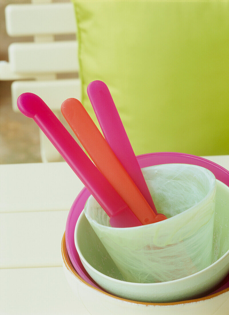Pink cutlery in green glass