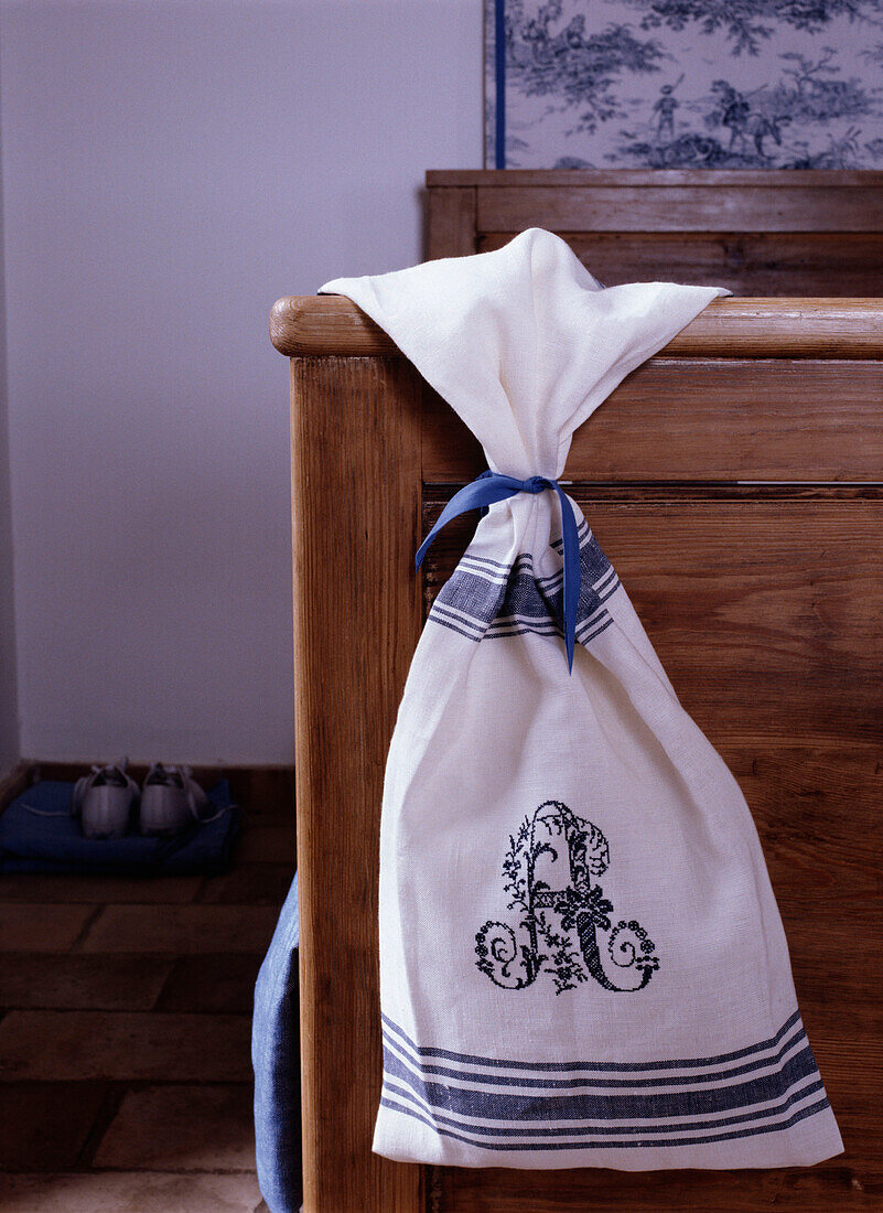 Linen cloth with embroidery leaning on the bed close-up