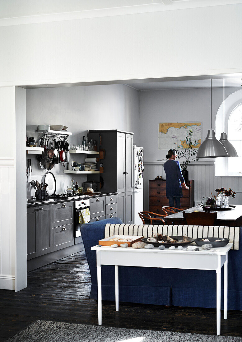 Open plan grey fitted kitchen in Lyme Regis home Dorset UK