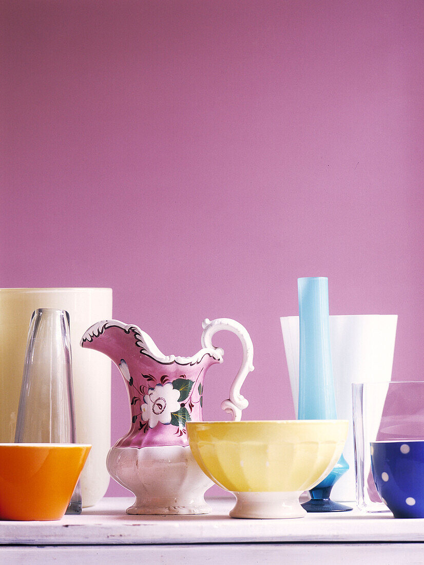 Assorted homeware set against pink wall