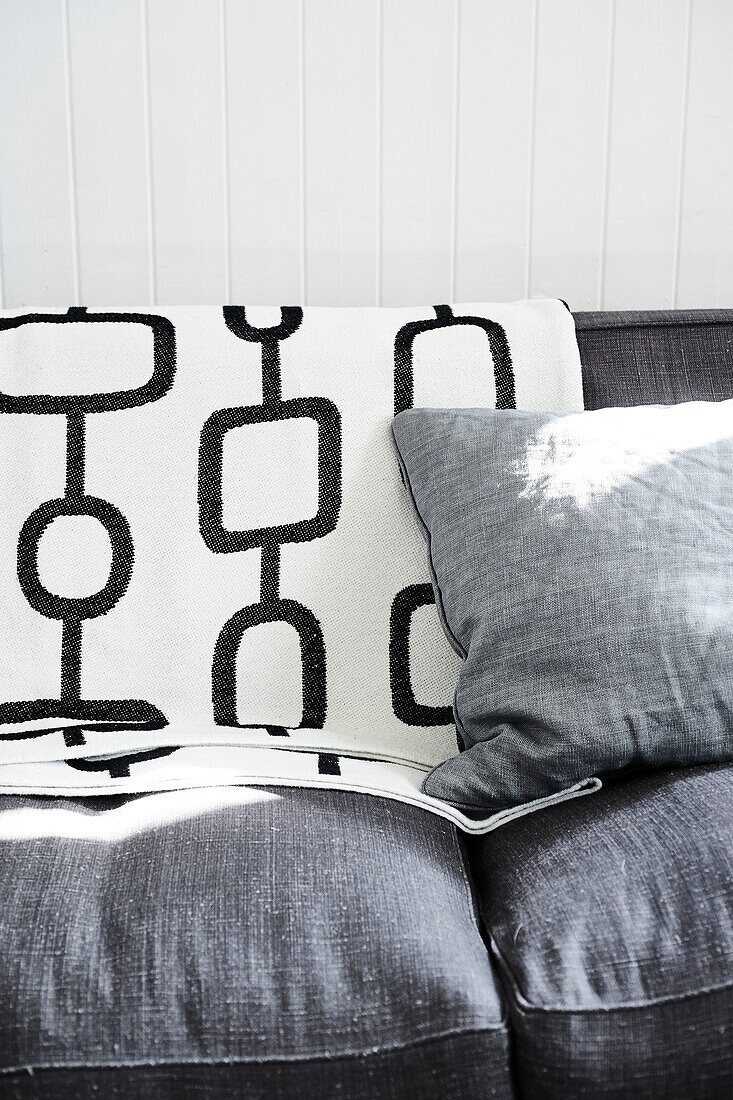 Black and white cushion on grey sofa in Lyme Regis home Dorset UK