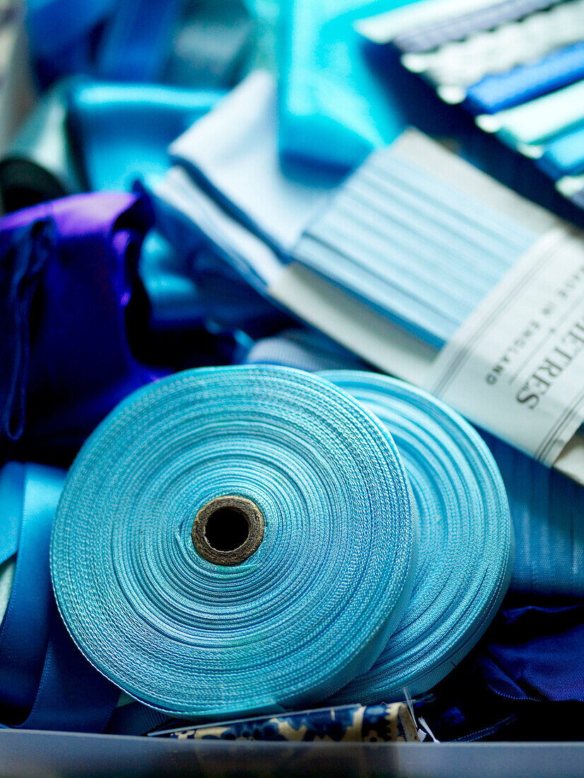 Turquoise spools of ribbon in craft box