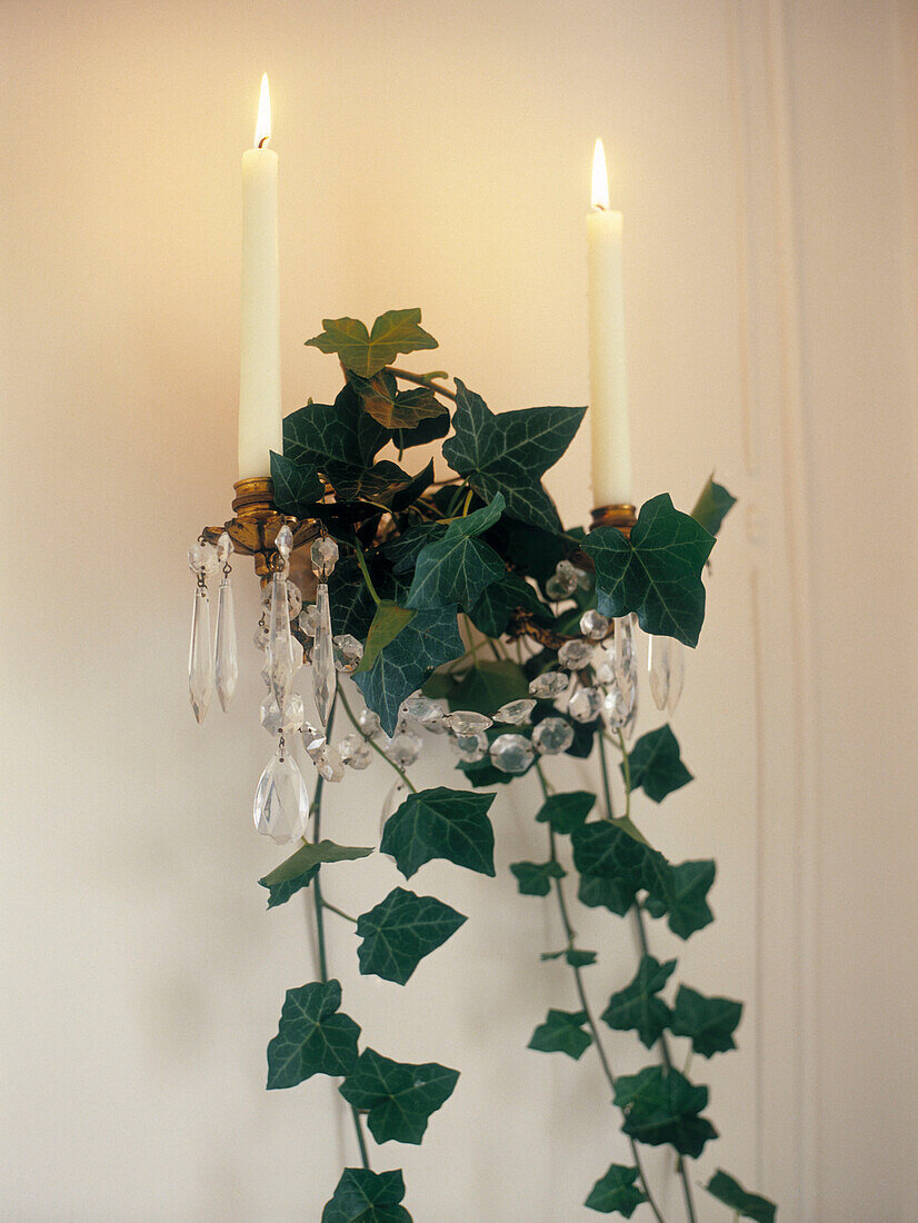 Lit candles and ivy