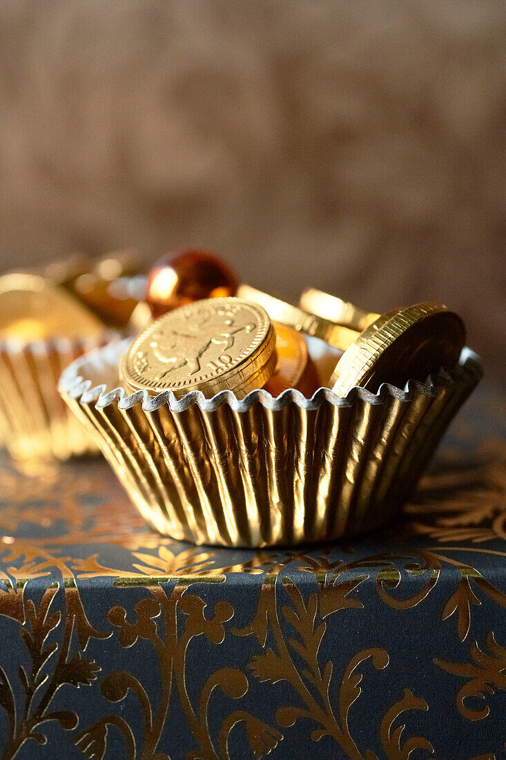 Chocolate coins in gold dish