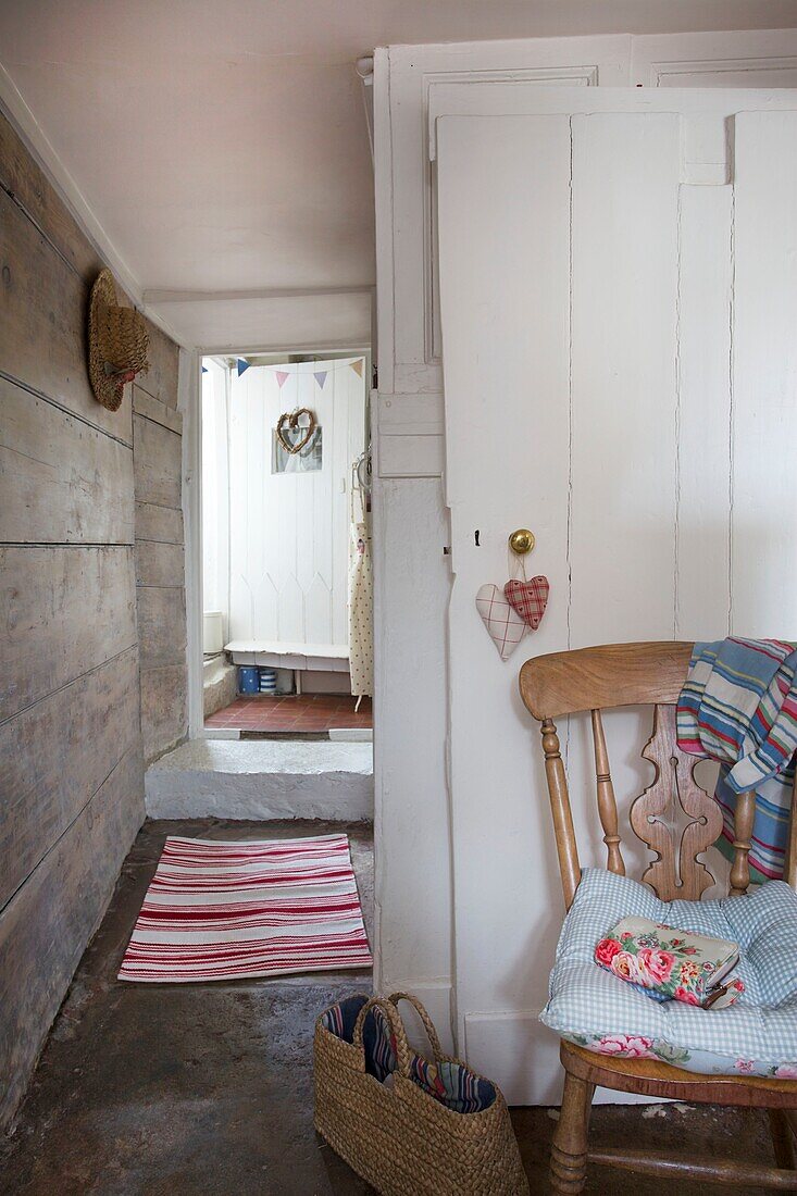 hallway entrance and open front door in Corfe Castle cottage, Dorset, England, UK