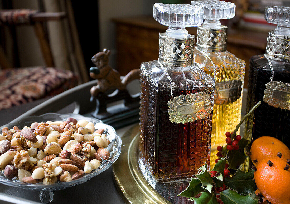 Bowl of nuts with vintage decanters in Tenterden home, Kent, England, UK