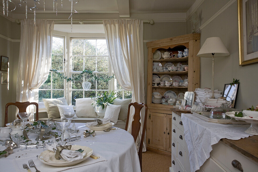 White dining room set for Christmas dinner in Tenterden home, Kent, England, UK