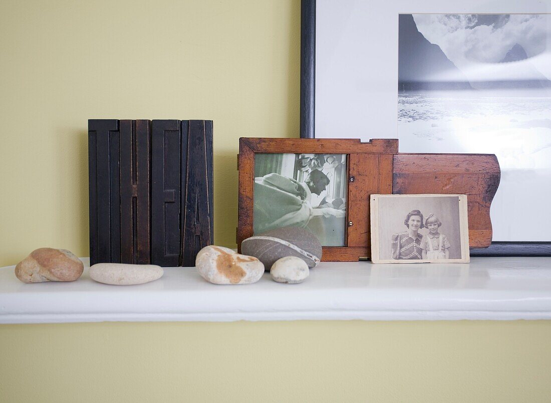 Shelf with photos and pebbles