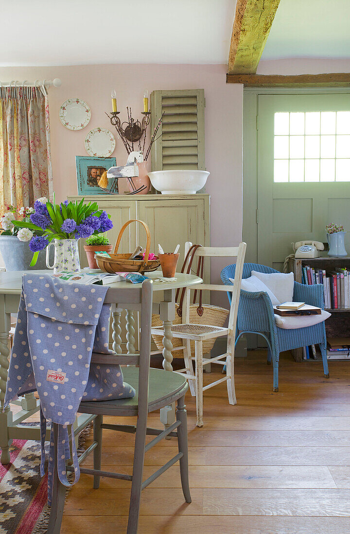 Spotted apron on chair at kitchen table in High Halden farmhouse Kent England UK