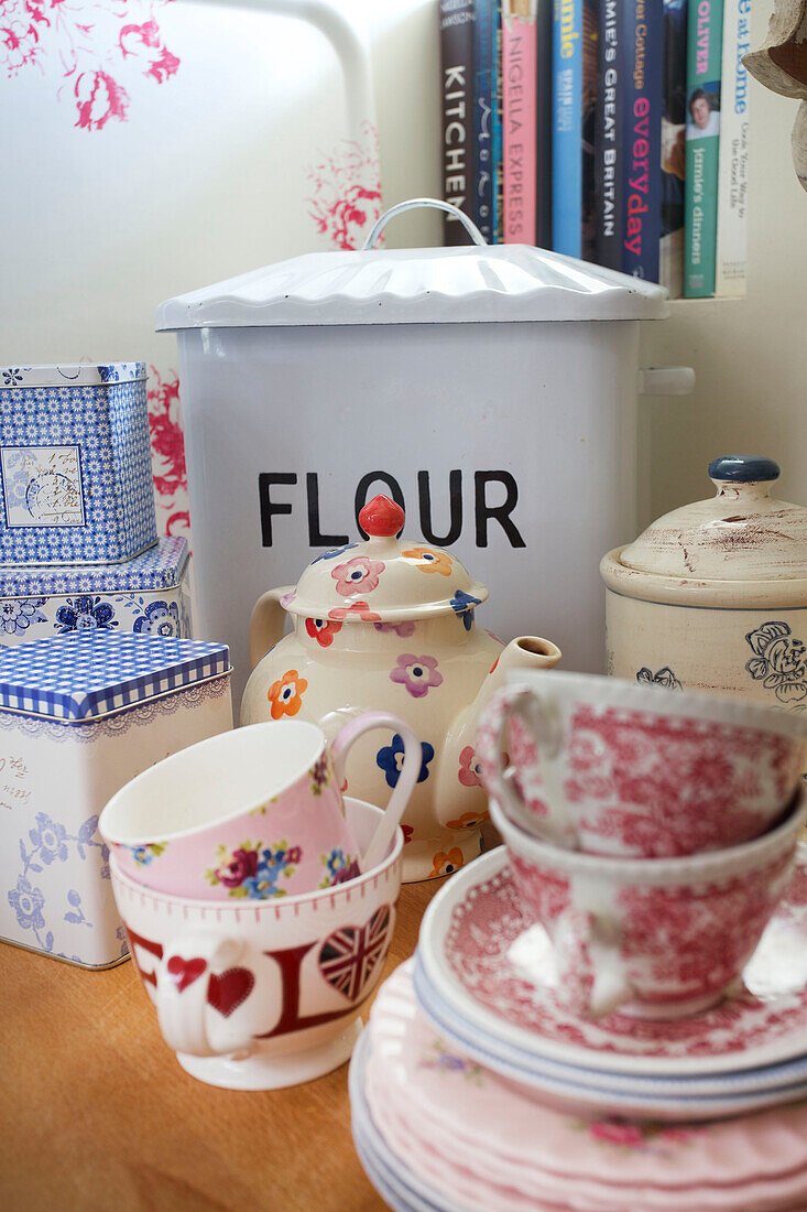 Flour bin and crockery with storage tins in High Halden farmhouse kitchen Kent England UK