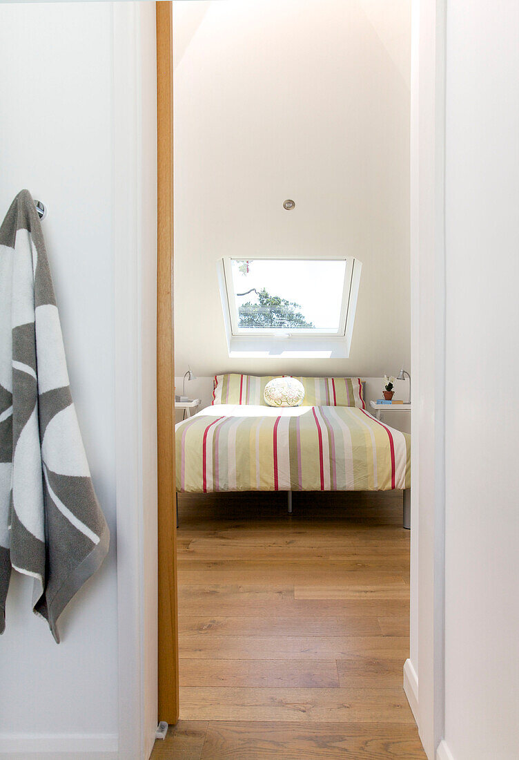 Bath towel on hook with view through doorway to bedroom in Rolvenden water tower conversion Cranbrook Kent England UK