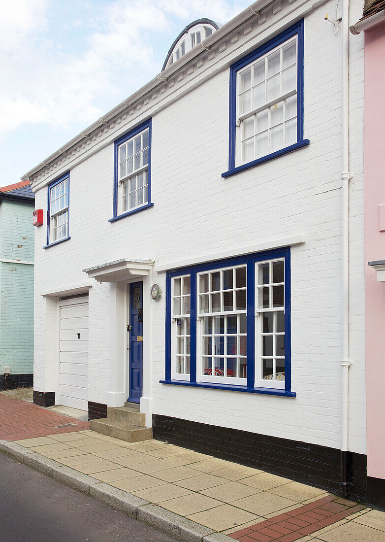 Whitewashed exterior with blue paintwork Emsworth beach house Hampshire England UK