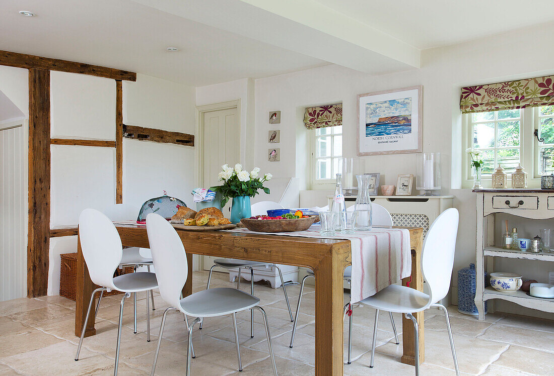 Wooden kitchen table with white chairs in Bishops Sutton kitchen Alresford Hampshire England UK