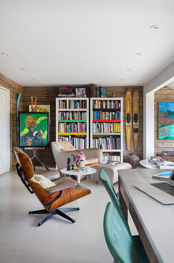 Chairs and bookcase in open plan Rye beach house East Sussex UK
