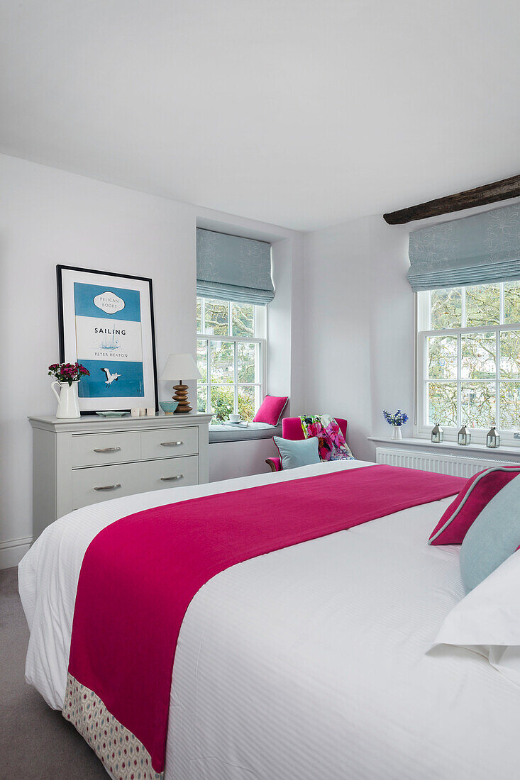 PInk runner on double bed with light blue roman blinds in Dartmouth Devon UK