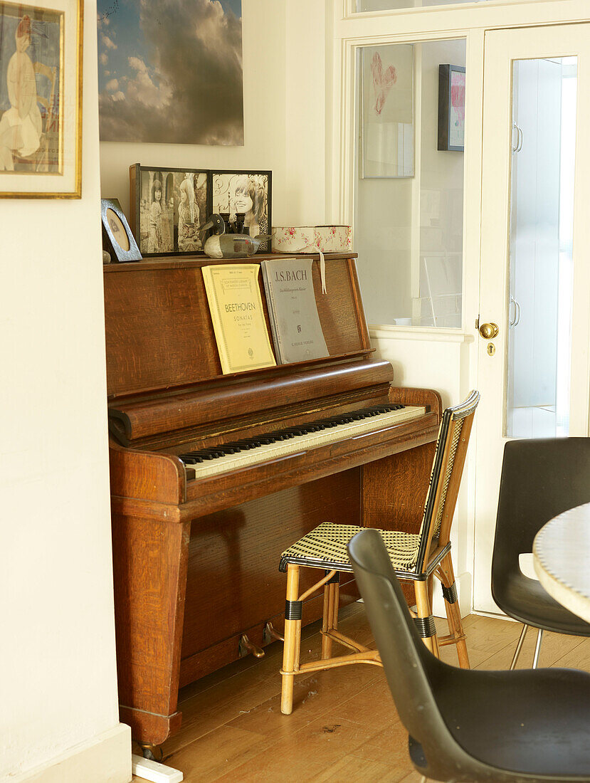 Wooden piano with sheet music in London home England UK
