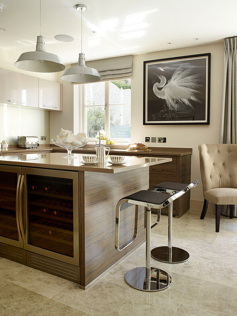 Black leather barstools at kitchen island in London townhouse, UK