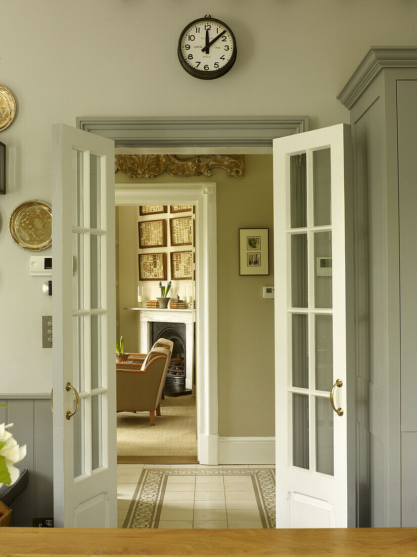 View through double doors across hallway in East Sussex country house England UK