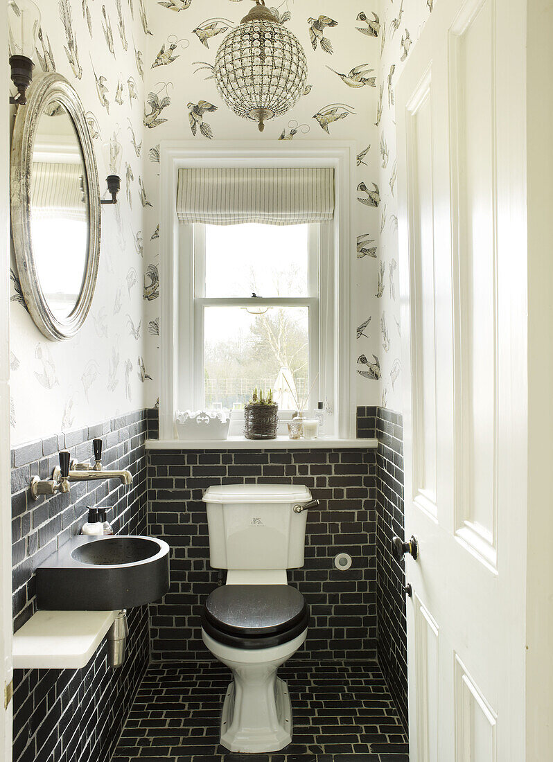 Black and white bathroom with silver framed mirror in East Sussex country house England UK