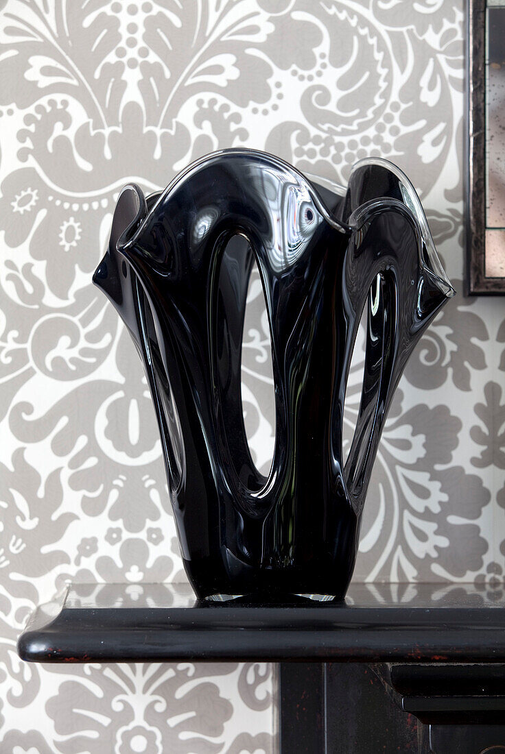 Block glossy vase and patterned wallpaper in contemporary London home, England, UK