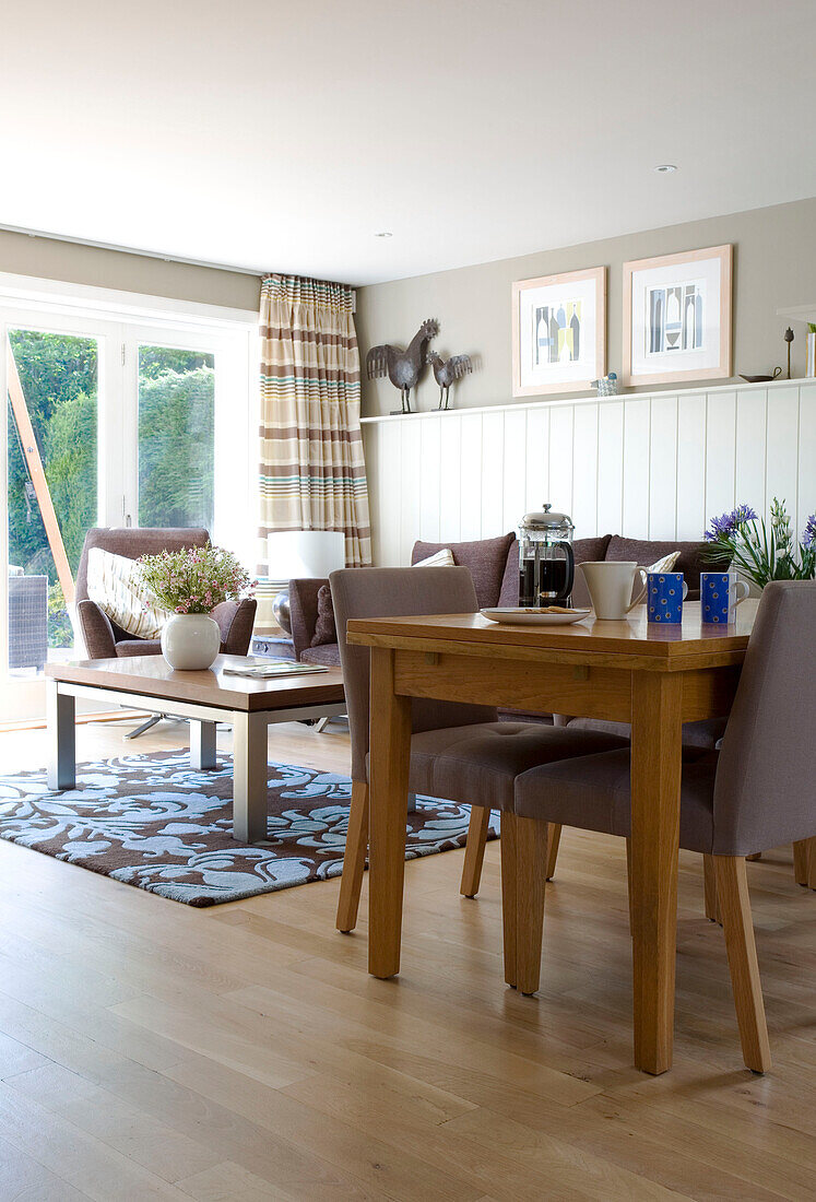 Dining table and chairs in open plan living room of Cambridgeshire home UK